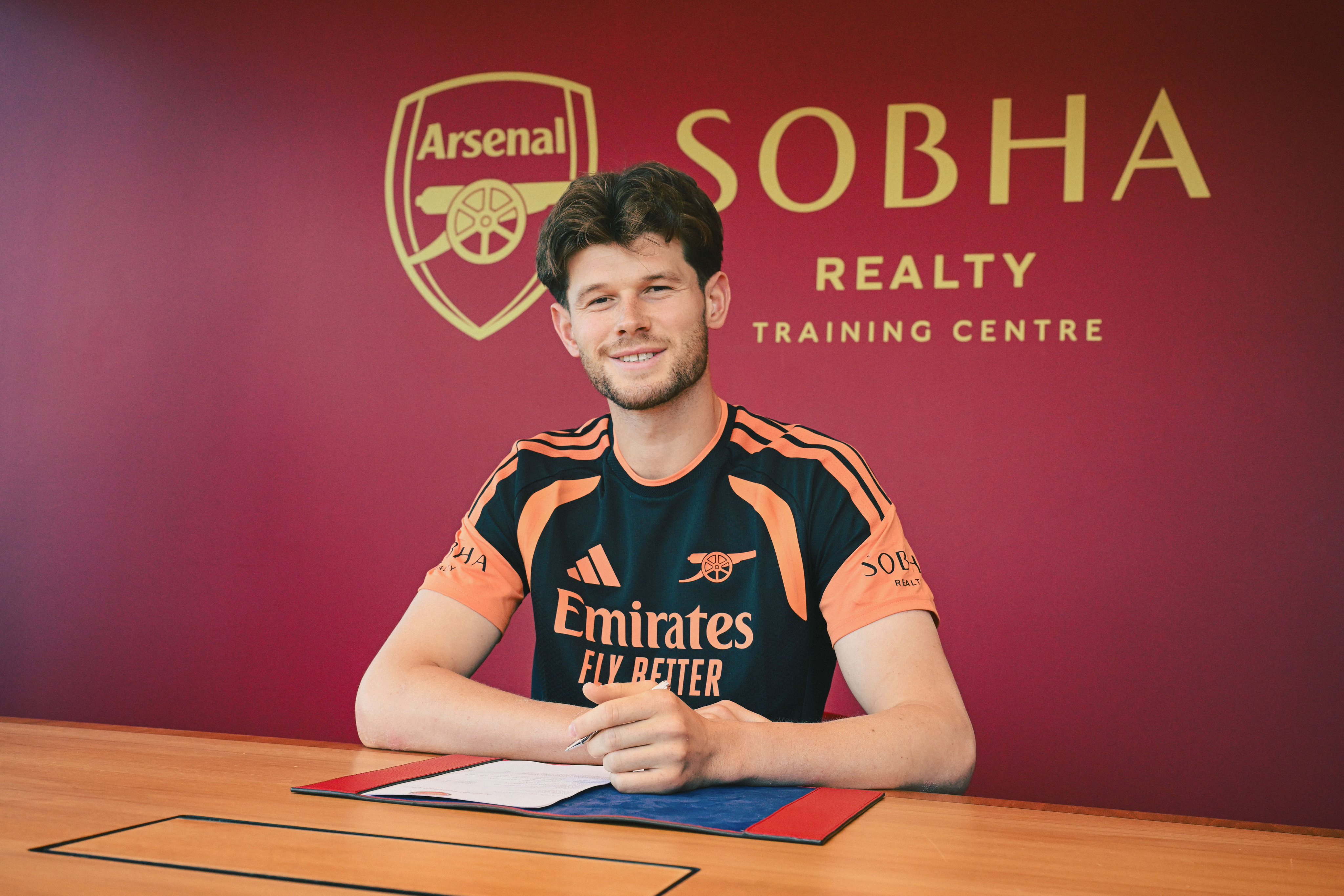 Illan Meslier signs his Arsenal contract at Sobha Realty Training Centre.